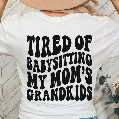 TIRED OF BABYSITTING MY MOMS GRANDKIDS UNISEX BELLA CANVA TSHIRT